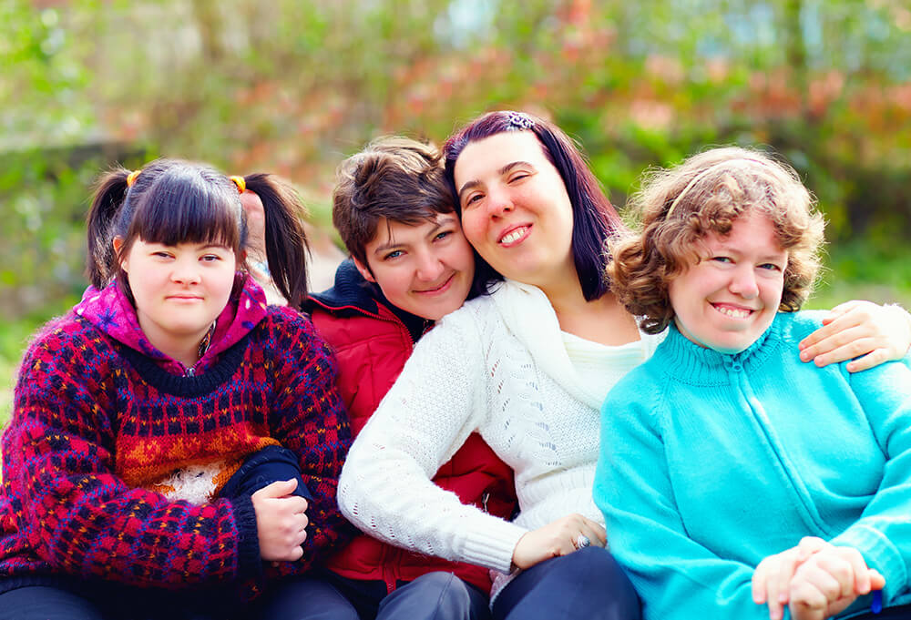 Group sitting down and hugging